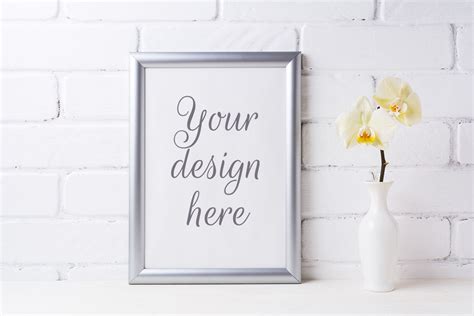 Download Silver frame mockup with soft yellow orchid in vase